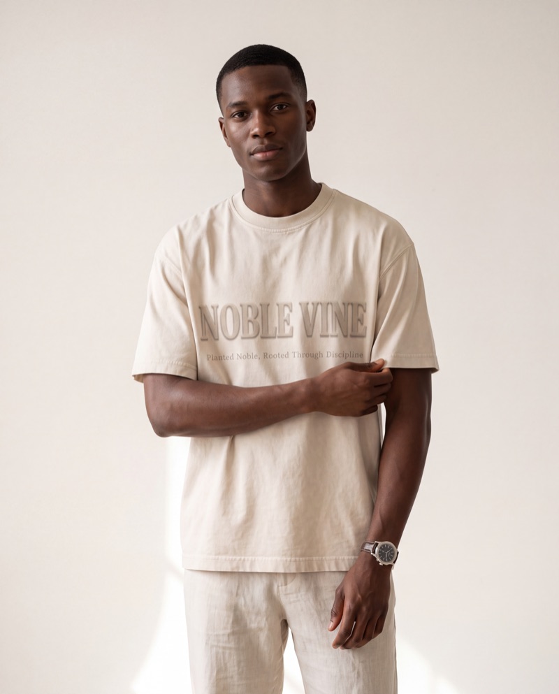 Model wearing the Black Nobility Tee in Mineral Cream